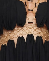 Close-up of the gold ring waist band and cut-outs