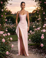 Helen blush satin maxi dress worn in a rose garden