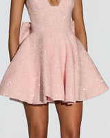 Waist bow and flared skirt detail