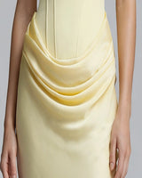 Close-up of draped satin sash at the hip
