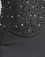Close-up of the scalloped hem of the beaded corset top