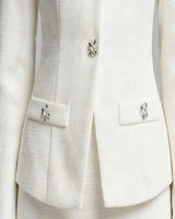Close-up of flap pockets with crystal buttons