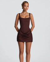 Cornelia plum brown corset mini dress with square neckline and draped satin skirt, studio front view