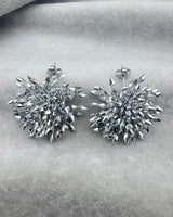 Ember silver firework cluster earrings — pair on velvet