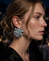 Ember silver firework cluster earrings — worn close-up