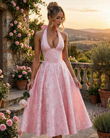 Effie blush midi dress worn on a rose garden terrace
