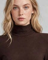 High neckline and padded shoulder detail