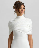 Close-up of the asymmetric twisted cape drape