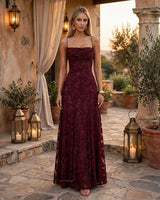 Francis cherry maxi dress worn in a Mediterranean courtyard