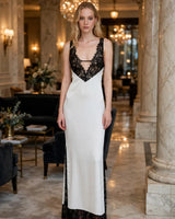Greta white lace-panel deep-V maxi dress — hotel lobby