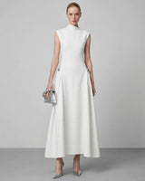 Paloma white high-neck pleated maxi dress — studio front