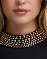 Close-up of the gold beaded mock collar