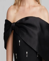 Close-up of oversized satin bow shoulder detail