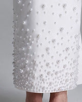 Close-up of pearl embellishment gathering at the hem