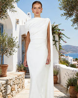 Visenta white asymmetric drape midi dress worn on a Mediterranean terrace