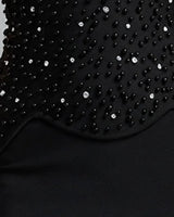 Close-up of the scalloped hem of the beaded corset top