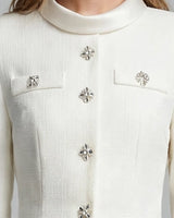 Close-up of crystal flower buttons and rolled collar